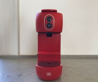 Illy ESE Coffee Maker in red on the countertop