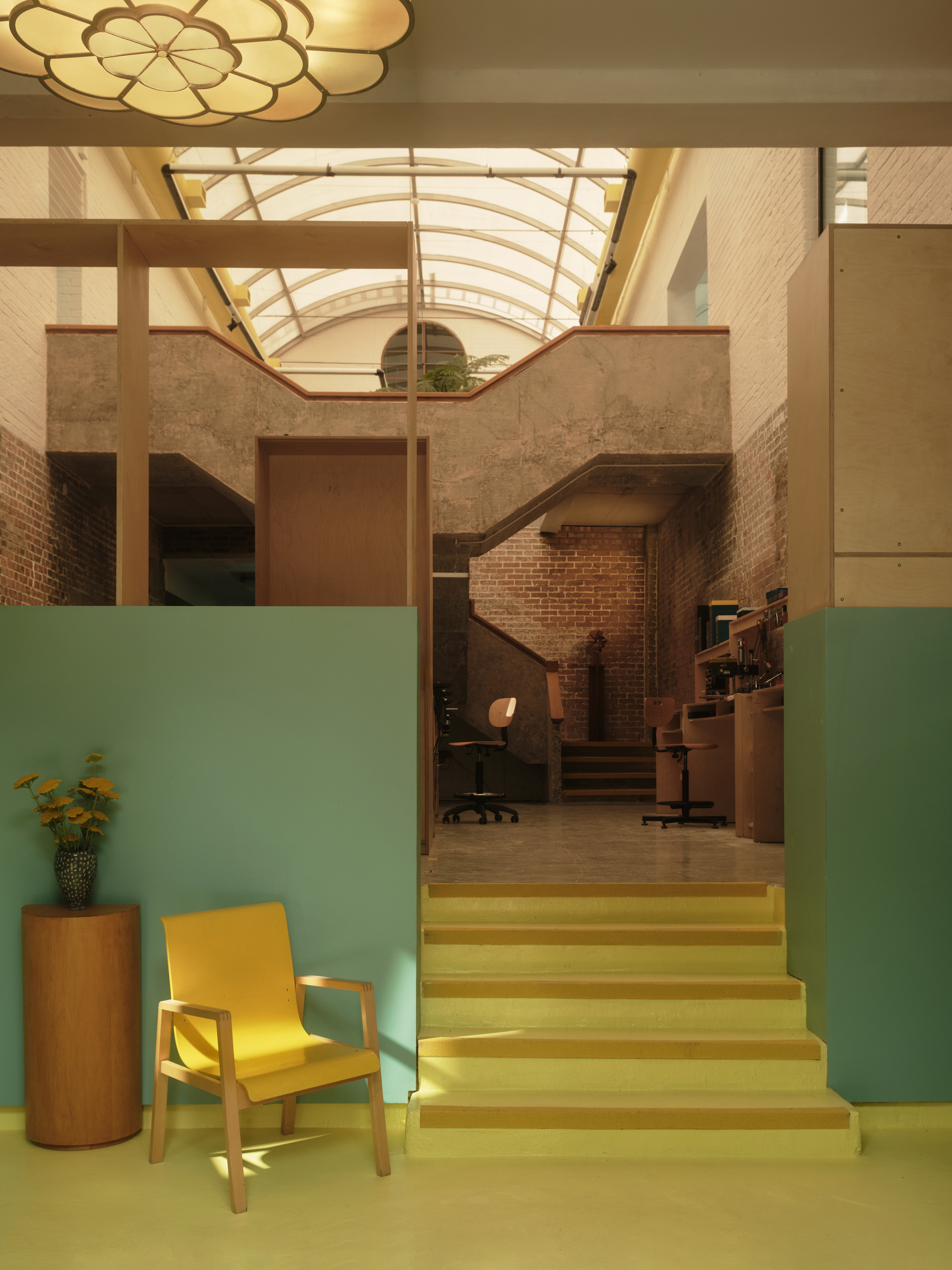 new Cubitts headquarters interior, refurbished warehouse type building with raw materiality and colour pops