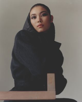 Woman model wearing black hooded coat