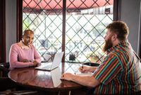 man and woman talking in a restaurant 