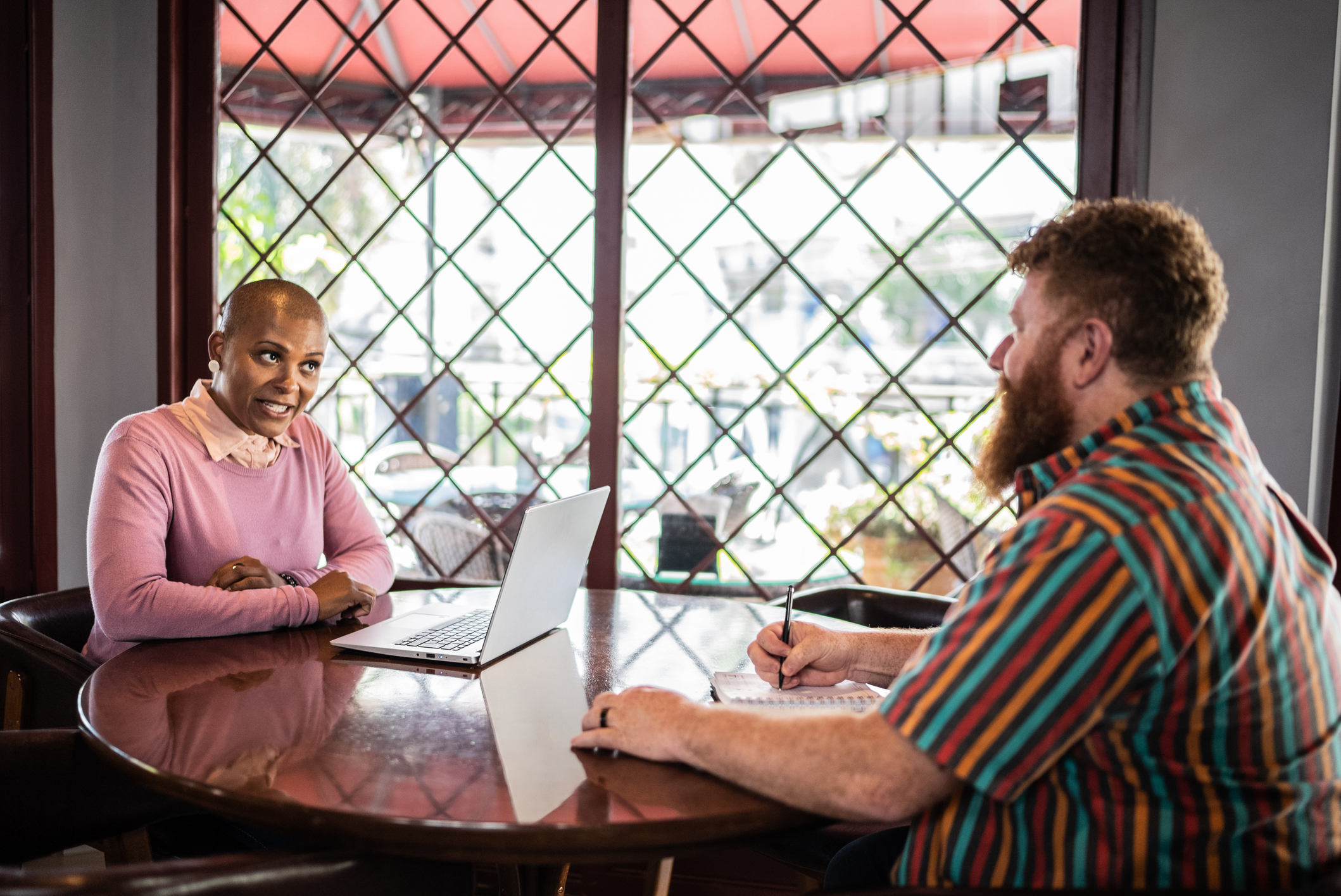 man and woman talking in a restaurant 
