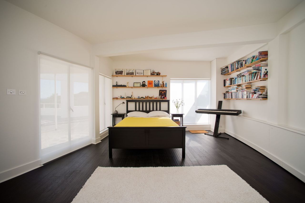A separate bedroom with wooden flooring