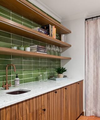 A kitchen with green tile backsplash