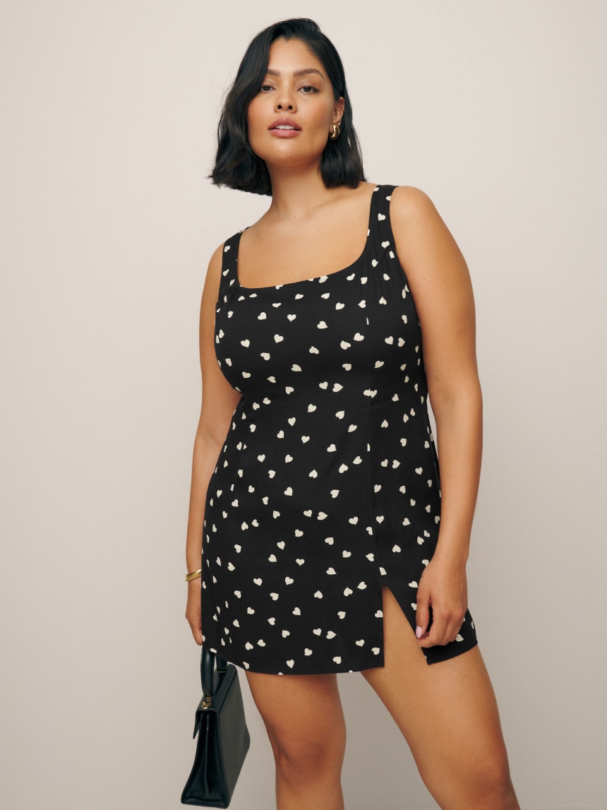 Reformation black mini dress with white printed hearts.