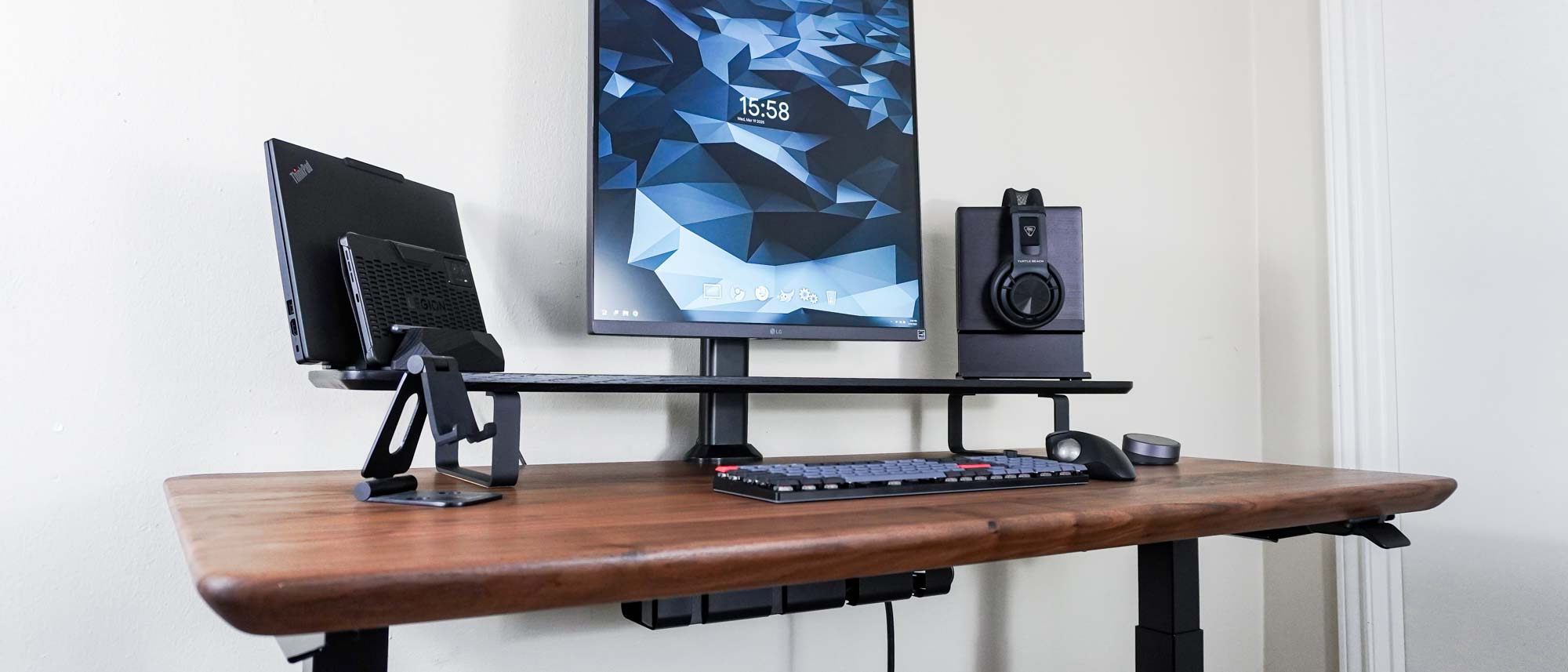 A desk setup with a single monitor, desk shelf and other accessories built around the Oakywood Standing Desk Pro