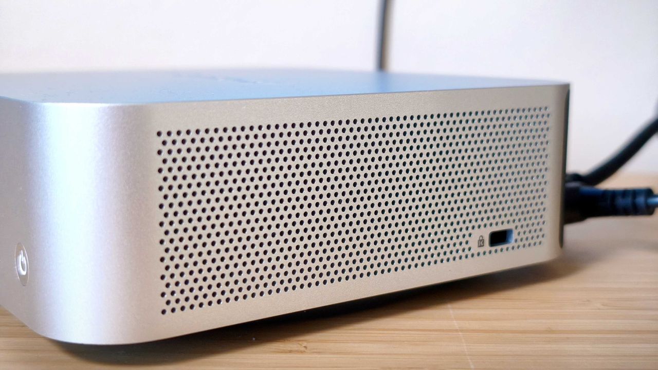 A silver Geekom A9 Max on a wooden desk