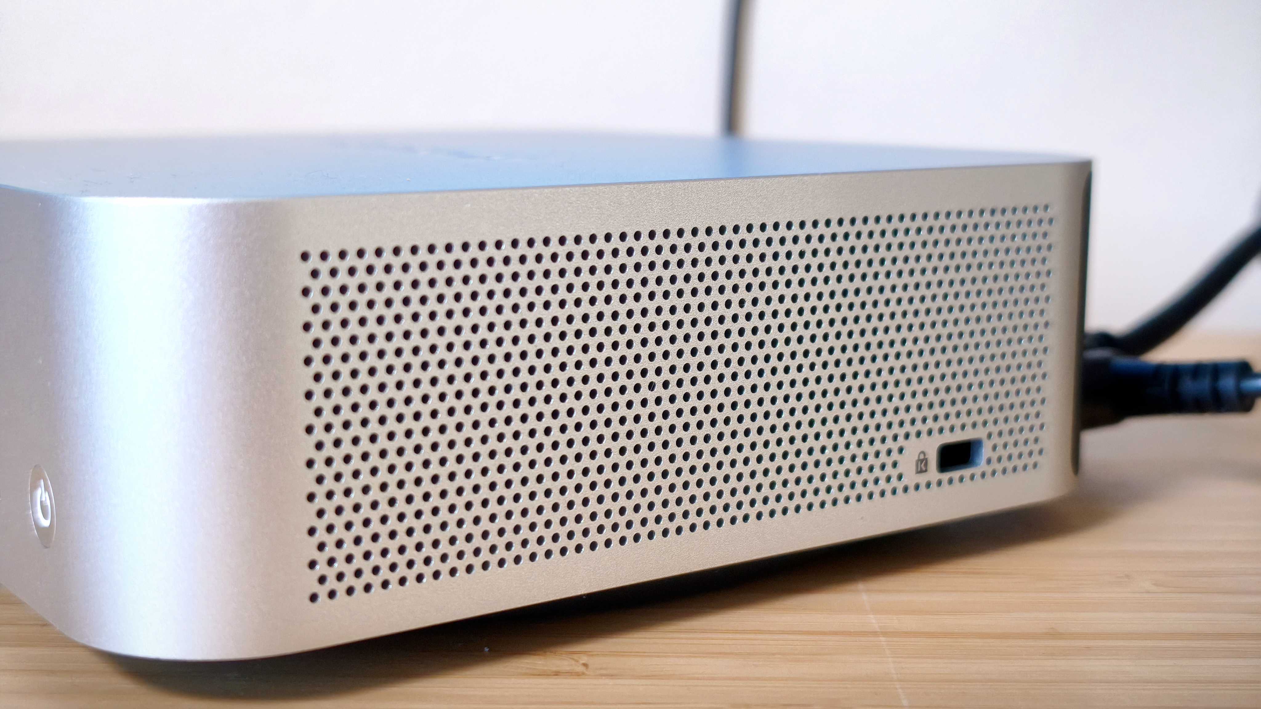 A silver Geekom A9 Max on a wooden desk