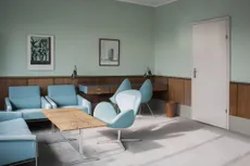a pale green hotel room with light blue chairs and wooden panelling