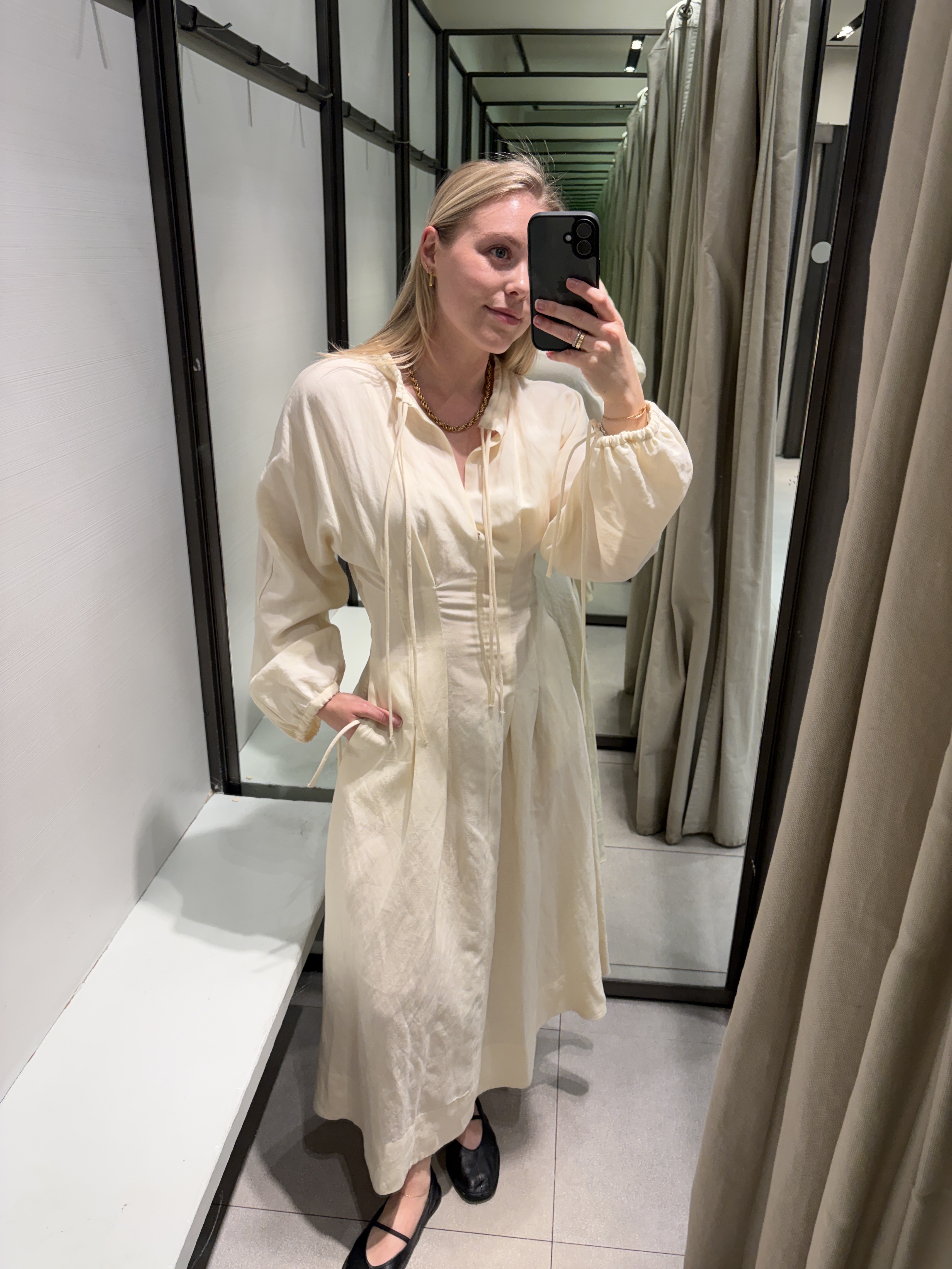 Woman wears cream dress from Zara, ballet flats