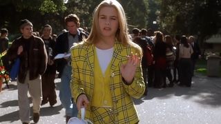 Cher wears a yellow plaid outfit to school in Clueless