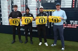 Four golfers pose with Open Championship flags