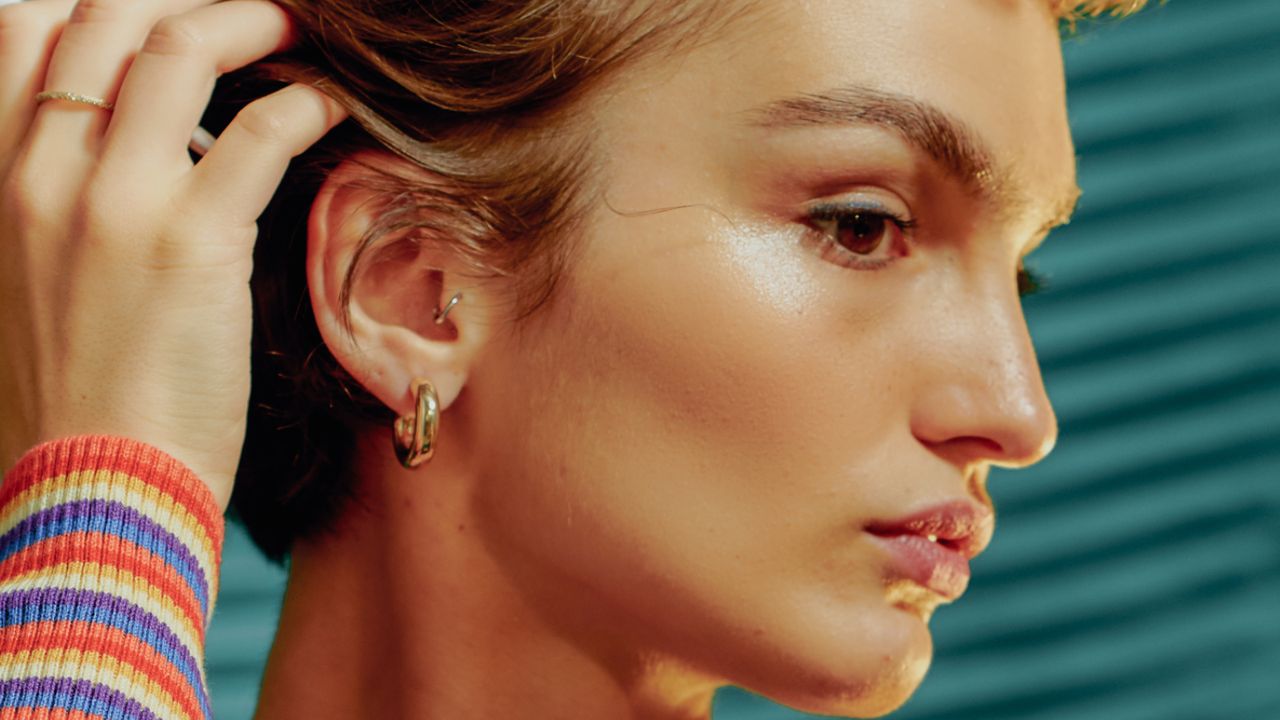 Woman with contoured cheekbones touching her hair - stock photo