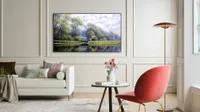 LG Gallery G1 OLED placed on a cream wall with furniture scattered around nearby