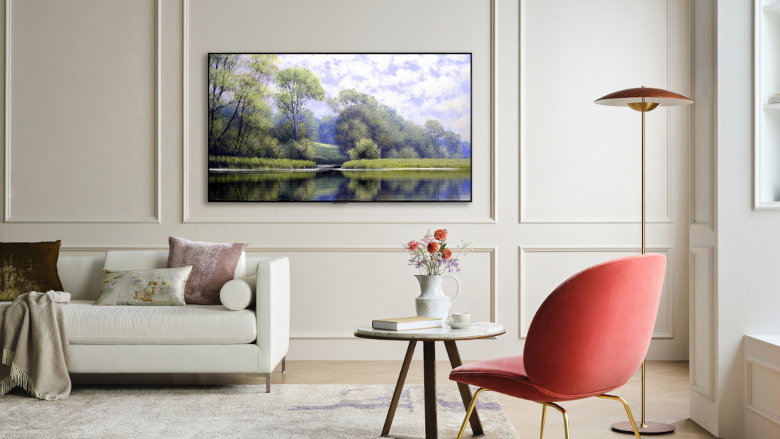 LG Gallery G1 OLED wall-mounted in a living room with chair and sofa