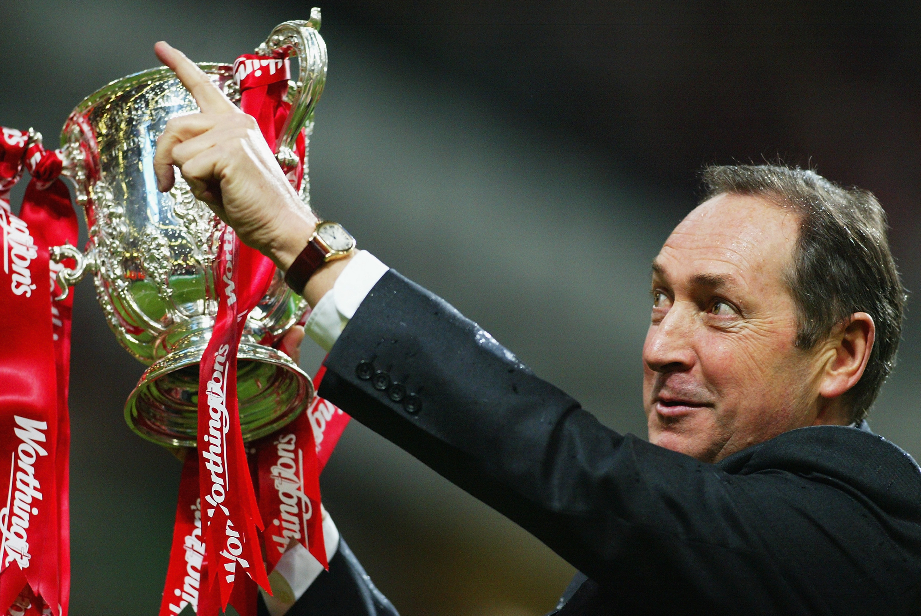 Gerard Houllier celebrates with the League Cup trophy after Liverpool's win over Manchester United in the 2003 final.