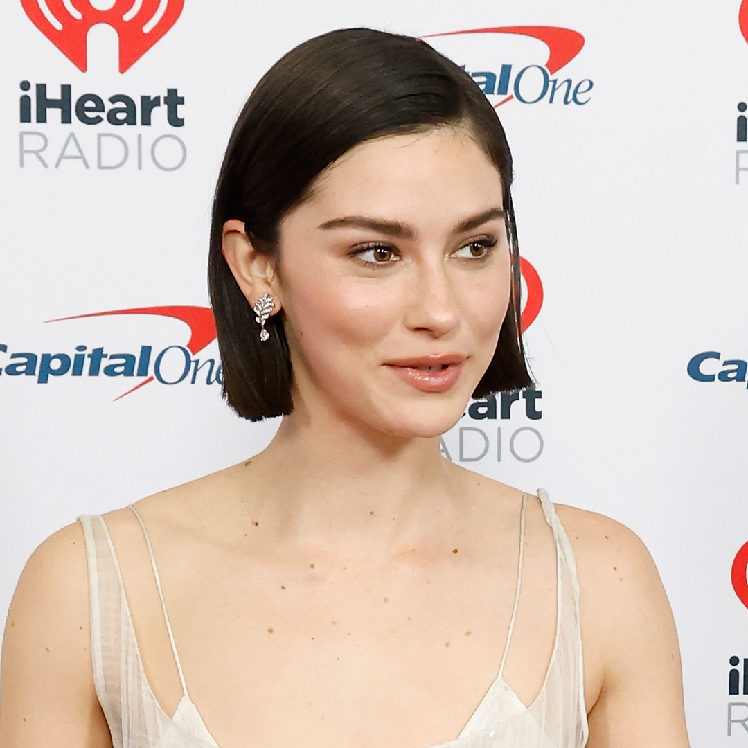 Gracie Abrams has a short bob and wears a sheer white strappy dress