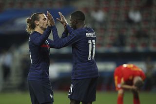 Ousmane Dembele celebrates with France’s Antoine Griezmann after scoring his side’s third goal
