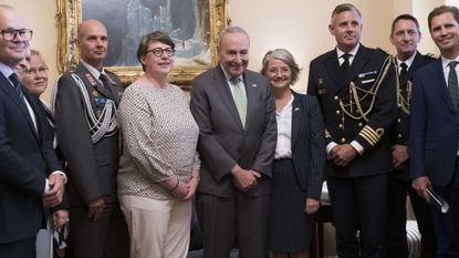 Senate Majority Leader Chuck Schumer, center, is flanked by Paivi Nevala, minister counselor of the Finnish Embassy, left, and Karin Olofsdotter, Sweden's ambassador to the U.S.