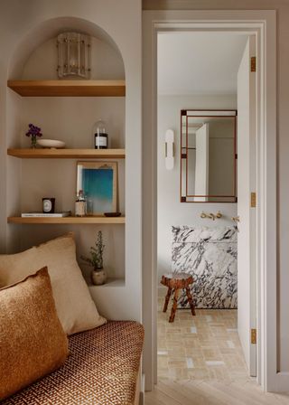 A living room leading to a powder room