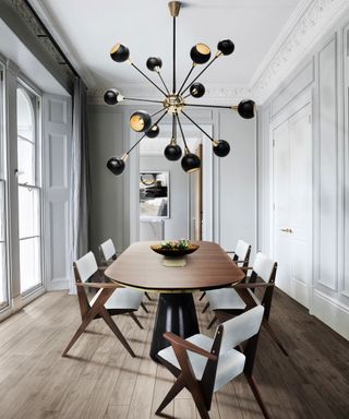 dining room with oval dining table and modern chandelier