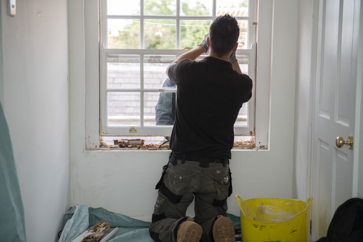 a worker repairing sash windows