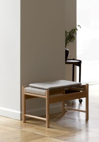 A brown rectangular stool with a grey top.