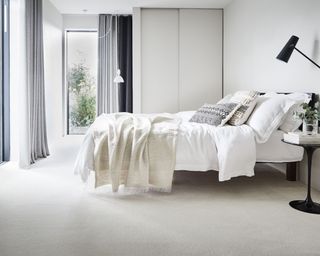 A cream bedroom with carpet