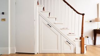 fitted storage under elegant staircase