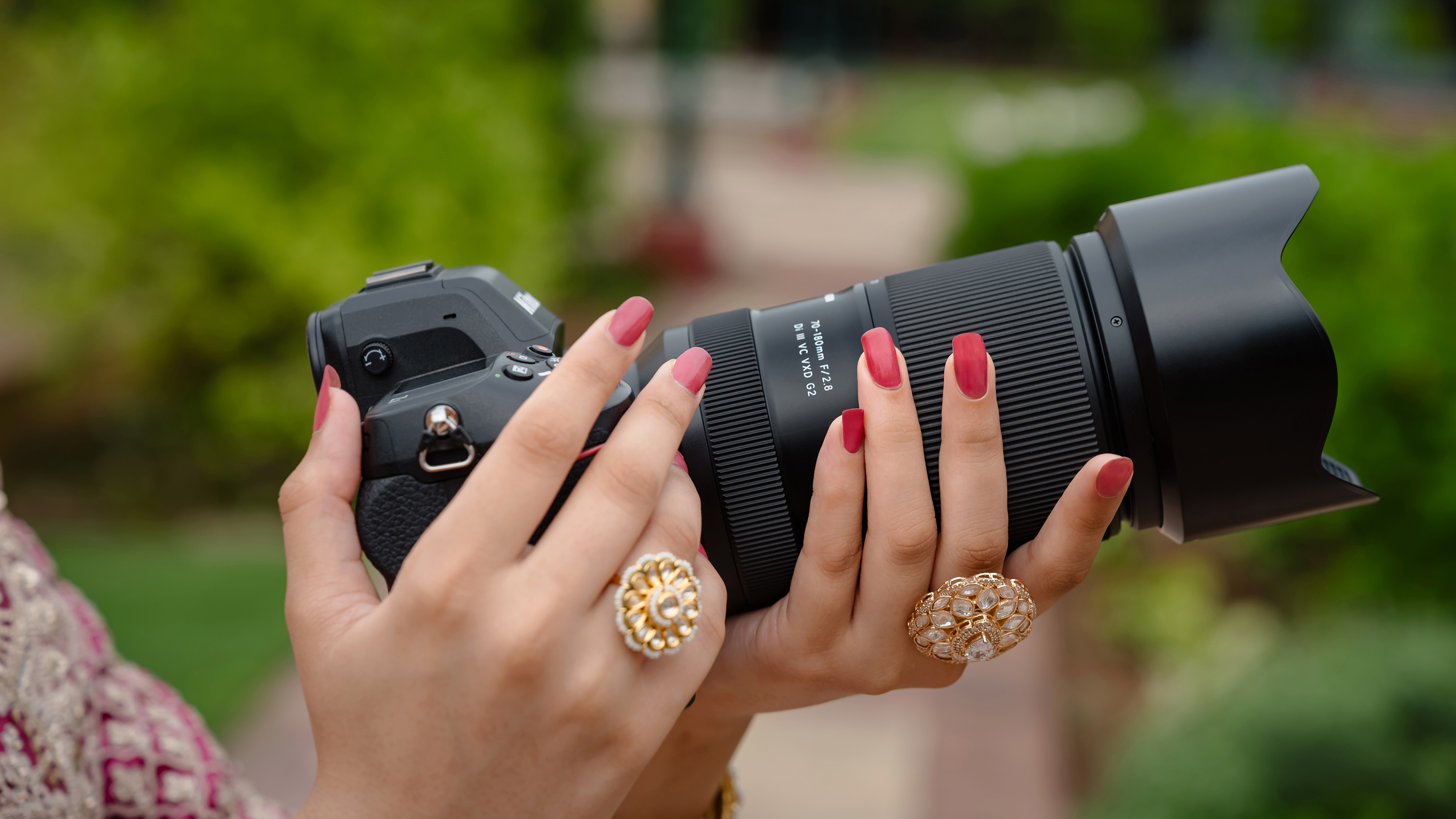 The Tamron 70180mm f/2.8 G2 lens in a person&#039;s hands