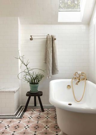 a bathroom with a patterned tile floor