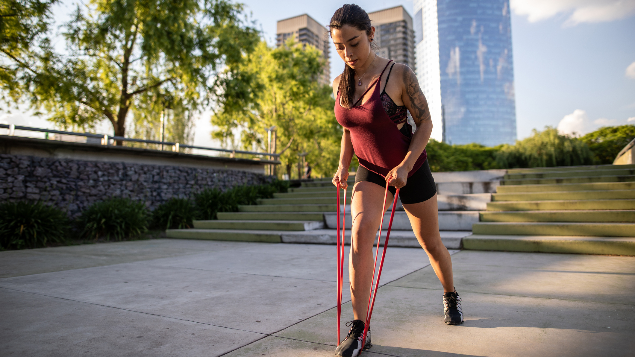 Woman exercising outside with resistance band
