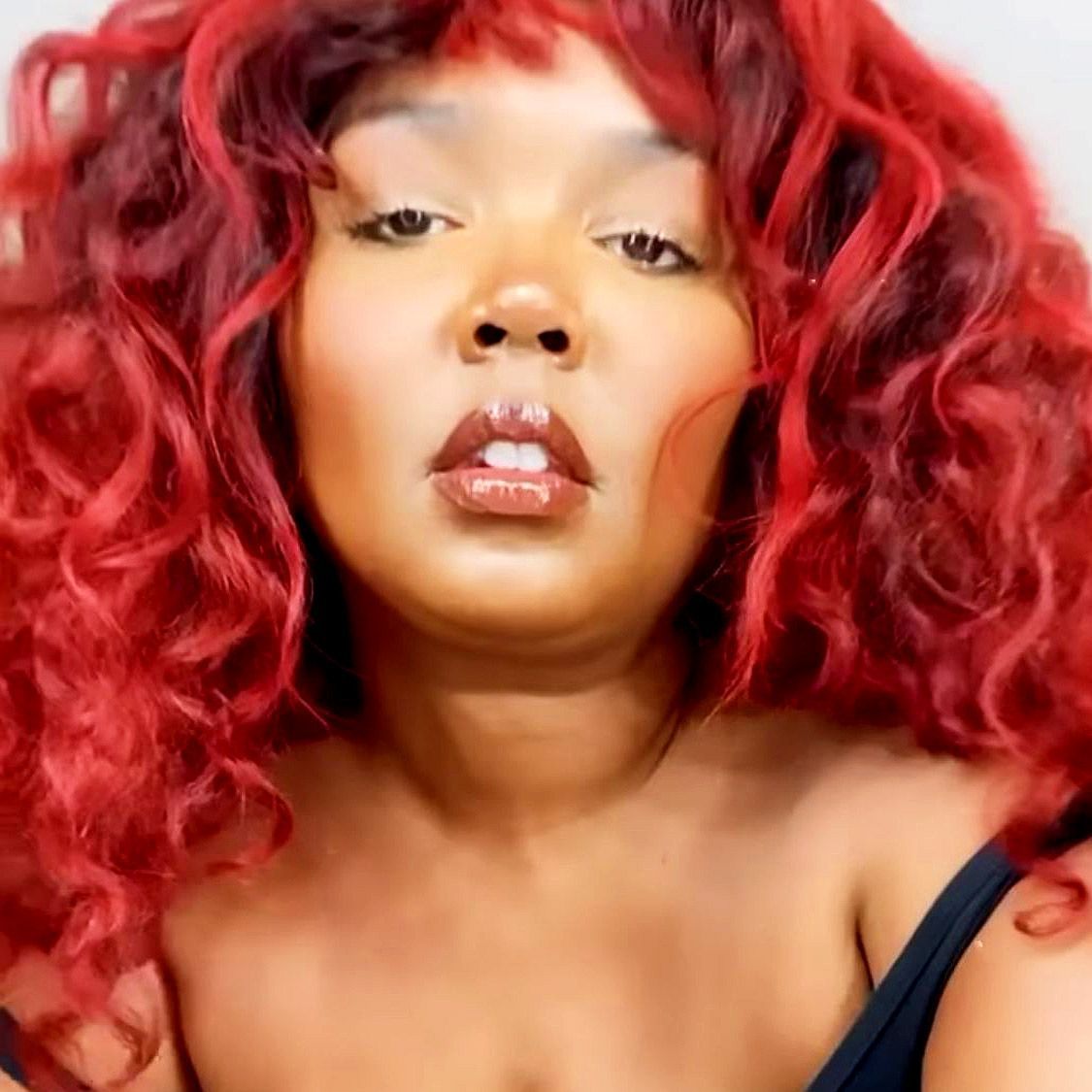 Lizzo Switched Up Her Look With Bright Red Hair and Bangs.