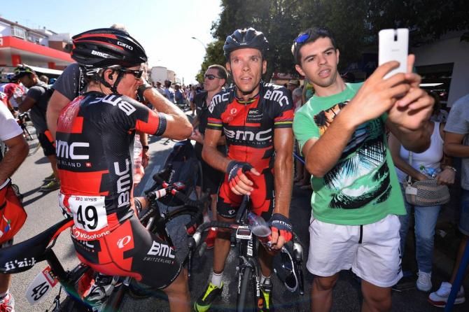 A fan gets a selfie with a tired Philippe Gilbert (BMC) after the stage