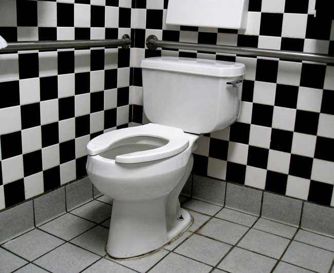 toilet in black-and-white tiled bathroom