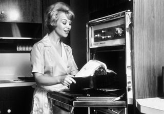 black and white photo of woman cooking