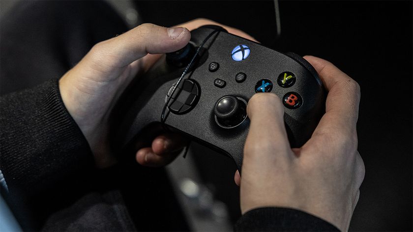Person holding a black Xbox controller