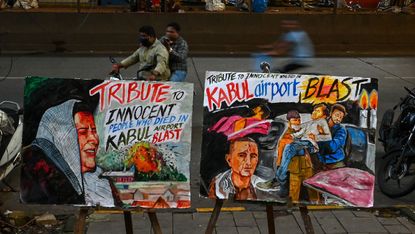 Tributes to the victims of the 26 August suicide bombing at Kabul airport, displayed on a street in Mumbai 