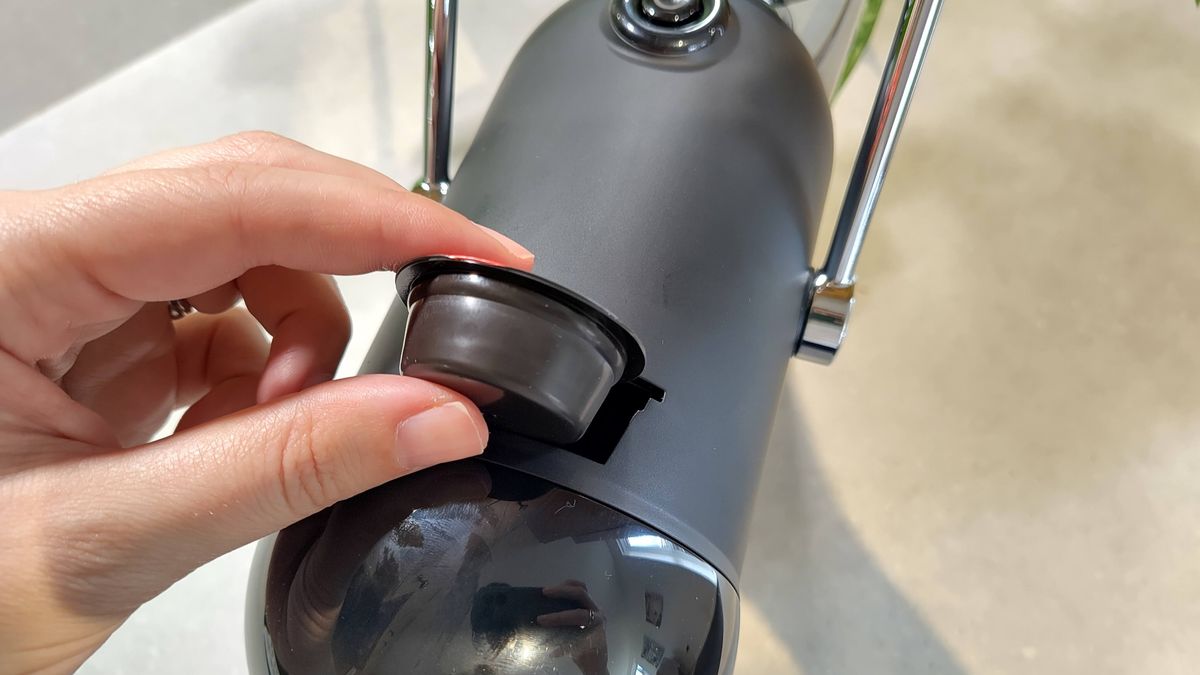 Person inserting coffee pod into Lavazza Jolie Evo coffee maker