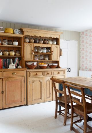 wooden kitchen with freestanding pantry and wooden table