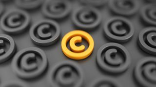 An orange copyright symbol in the middle of several gray copyright symbols