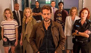 Harrow Ioan Gruffudd stands in front of the cast, lined up in a hallway