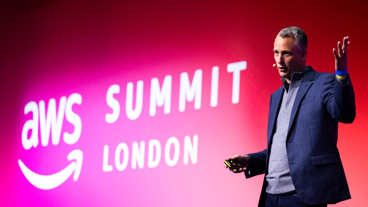 A telephoto shot of Pieter Jordaan, CIO at TUI, speaking onstage at AWS Summit London 2024.