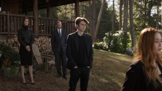 Ty Simpkins stands in the middle of the funeral scene of Avengers: Endgame.