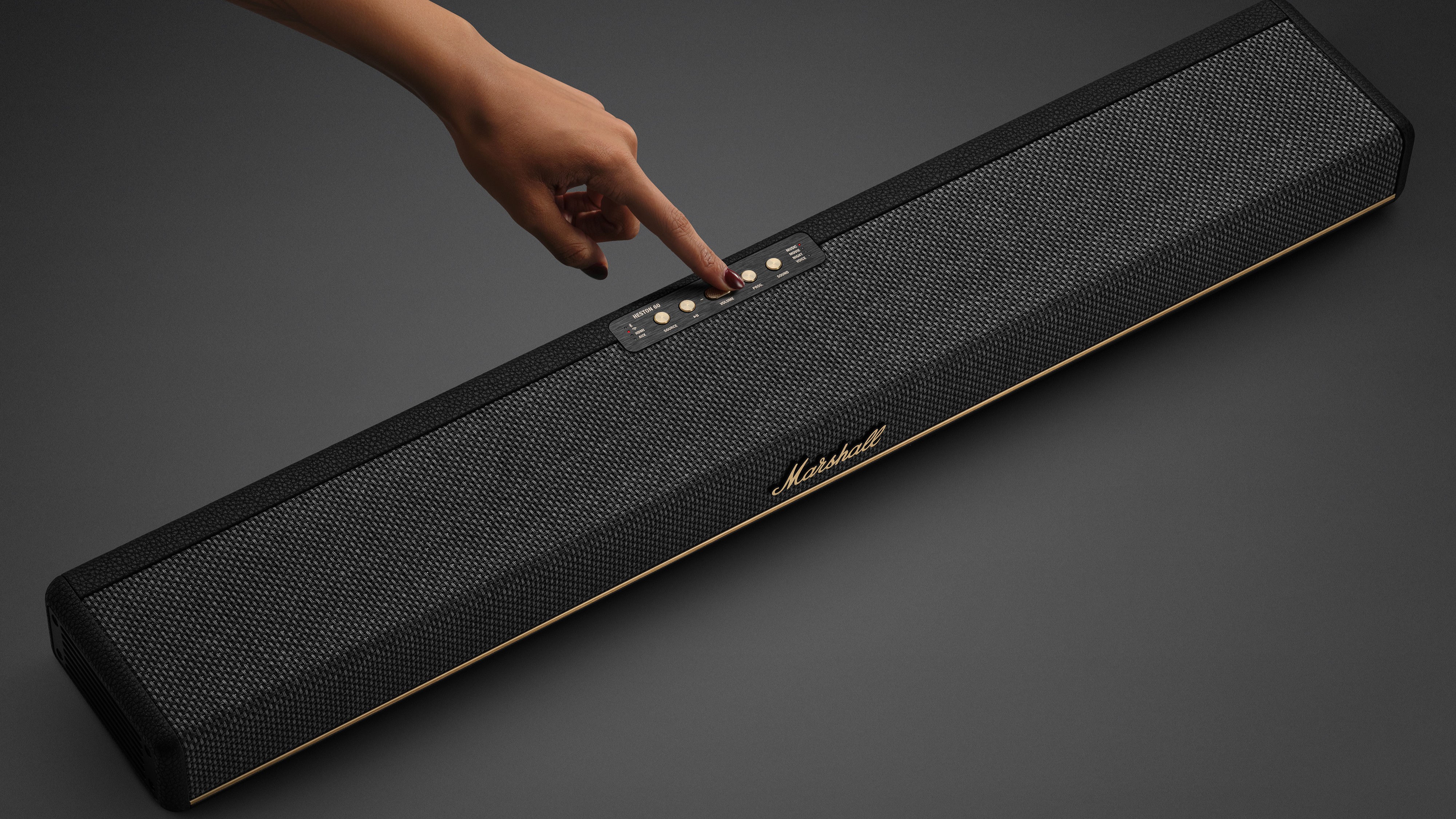 Person pressing the play button on the Marshall Heston 60
