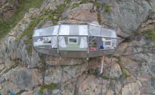 prism-like cabins hanging on mountain