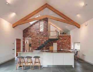 inside of a timber frame extension with white scheme and high ceilings by van ellen + Sheryn architect