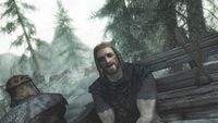 Ralof sitting in a prisoner wagon chatting to the Dragonborn during the opening of Skyrim.