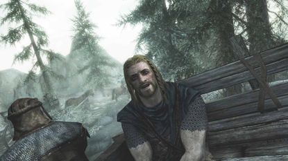 Ralof sitting in a prisoner wagon chatting to the Dragonborn during the opening of Skyrim.