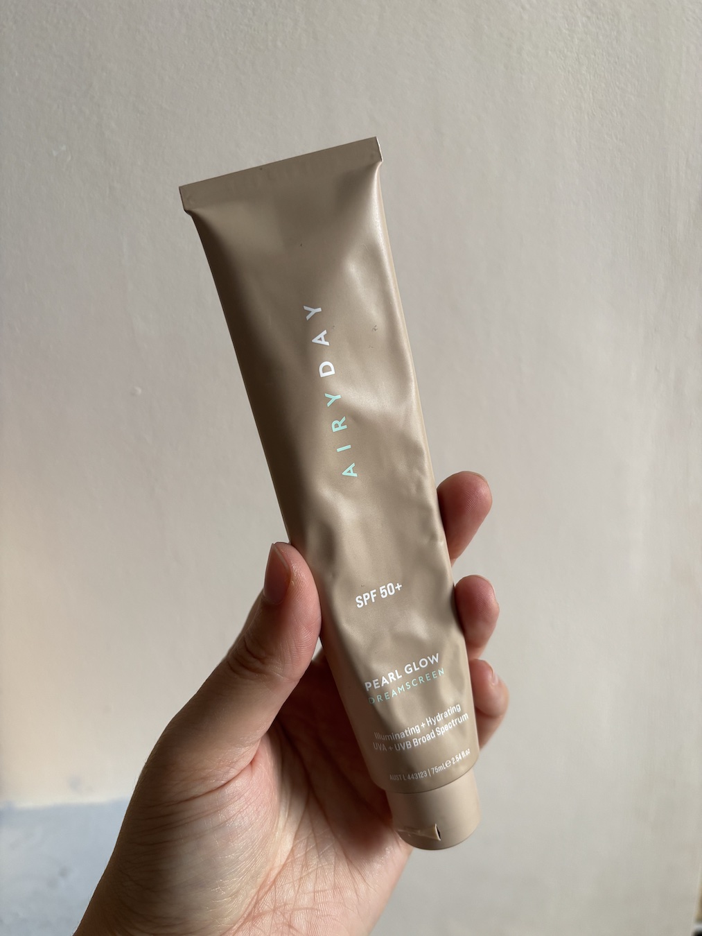 Mica Ricketts holding Airyday Pearl Glow SPF50+ Dreamscreen
