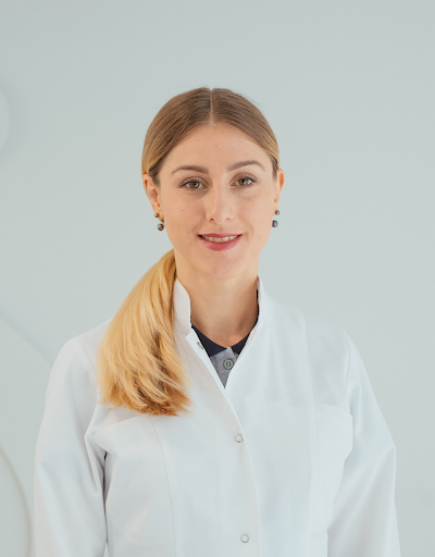 woman in lab coat poses for a headshot
